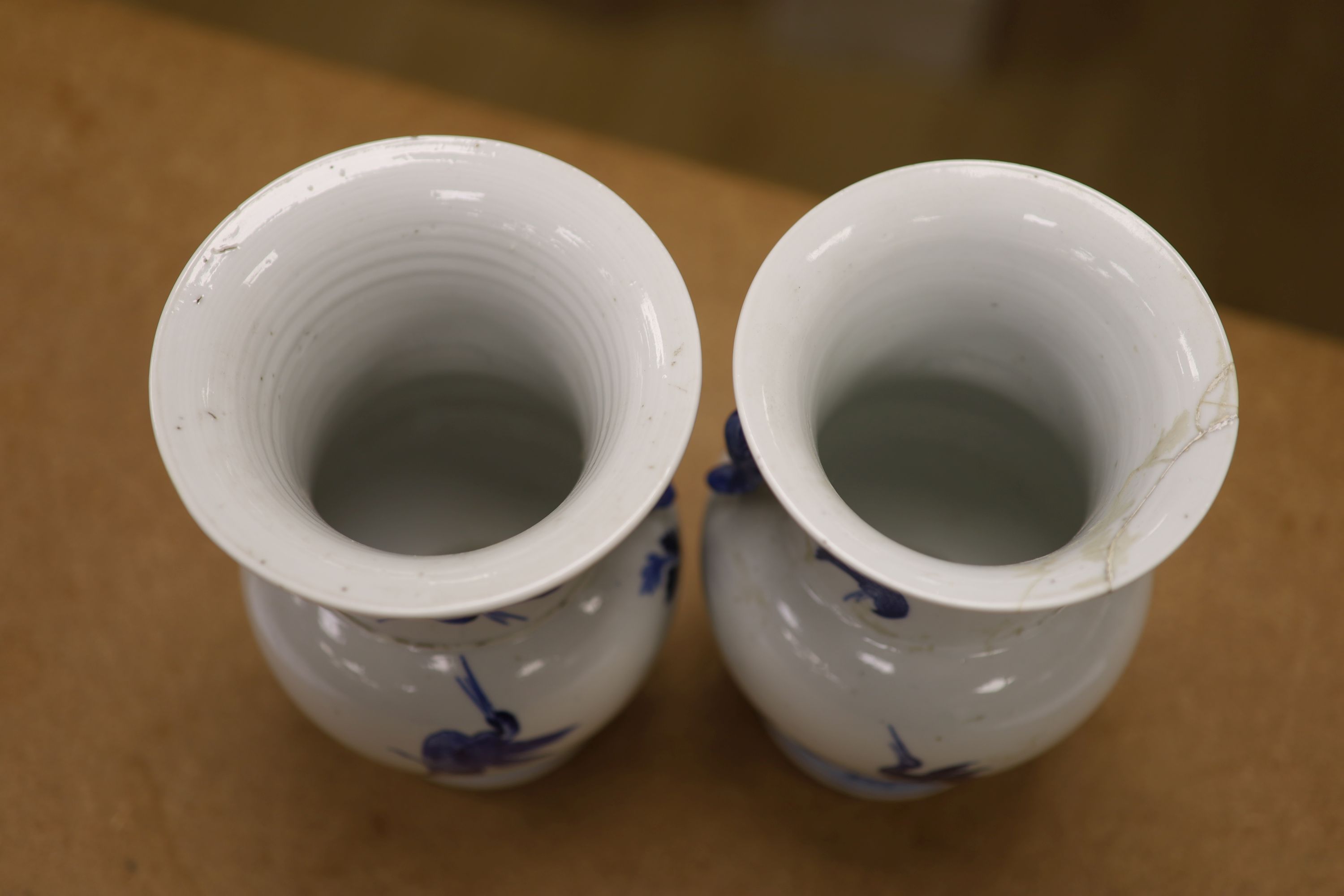 A pair of Chinese blue and white 'phoenix' vases, Kangxi marks but late 19th century, height 20cm (a.f.)